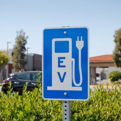 A view of a city sign and symbol for electric vehicle parking an